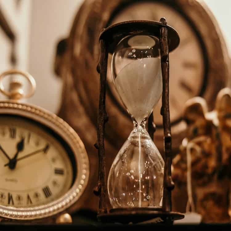 Antique hourglass and vintage clocks on display