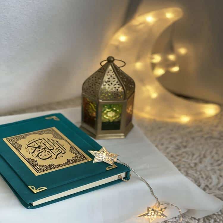 Decorative lantern and book with fairy lights.